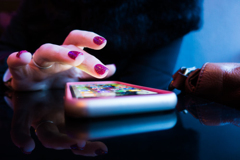 Close-up of a woman's hands using a smartphone.